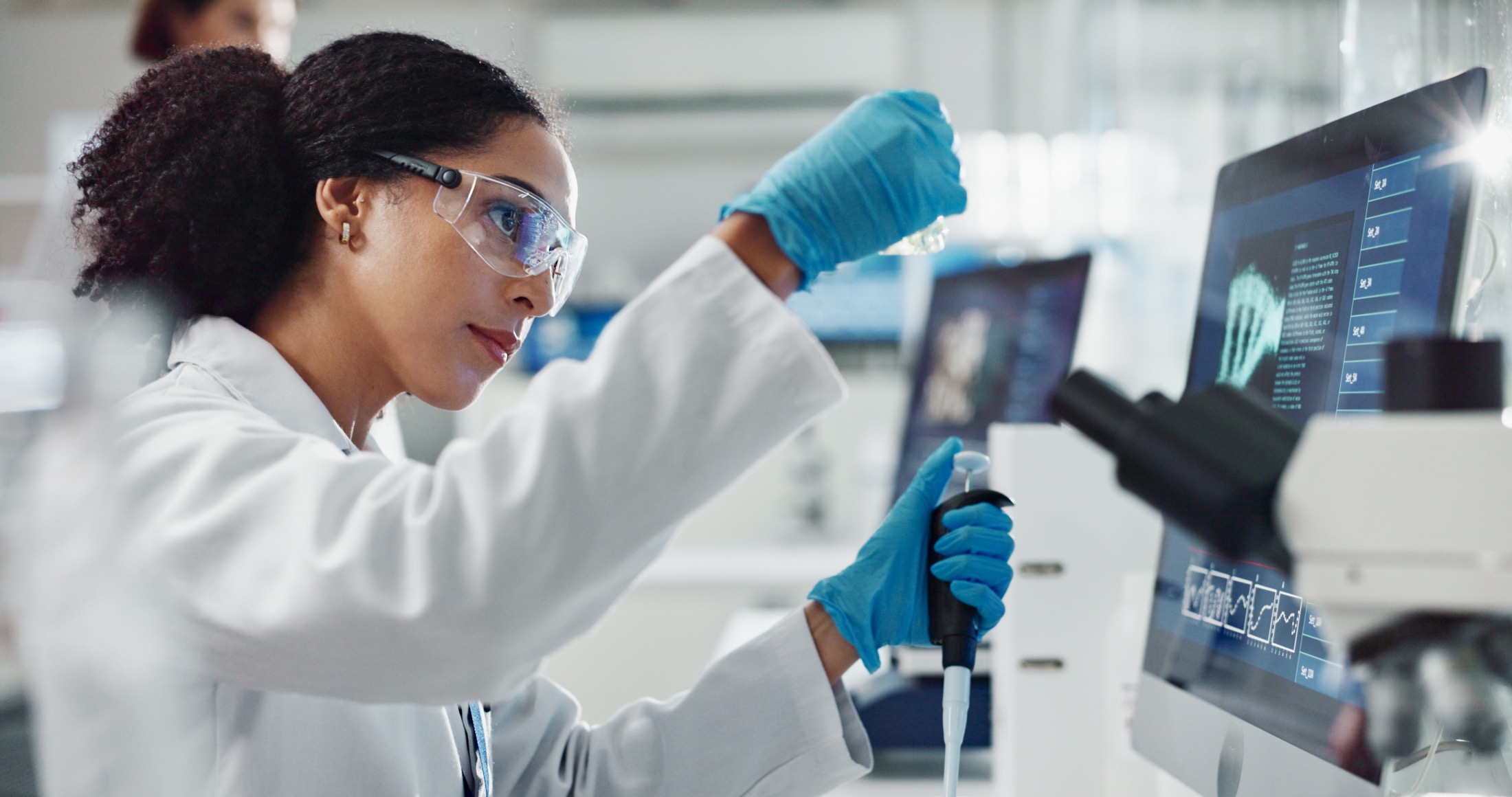 A laboratory scientist preparing and reviewing molecular sample data